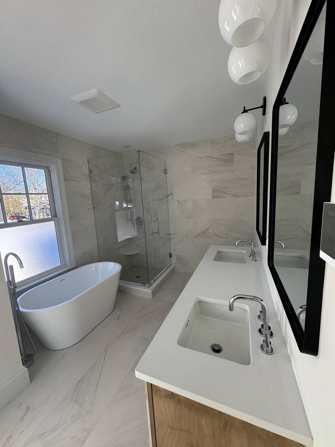 Bathroom with freestanding tub and wood vanity