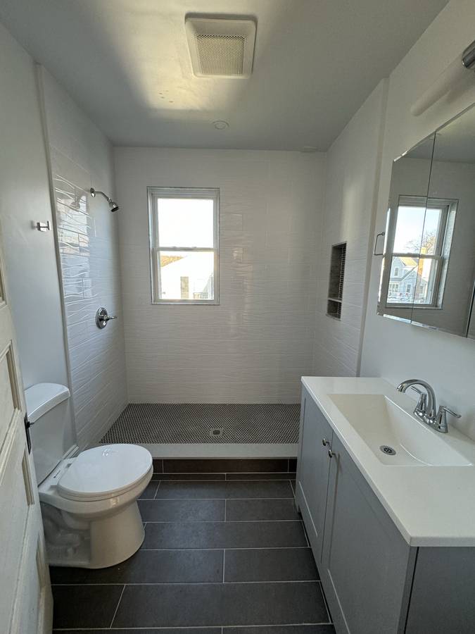 White tile bathroom with walk-in shower
