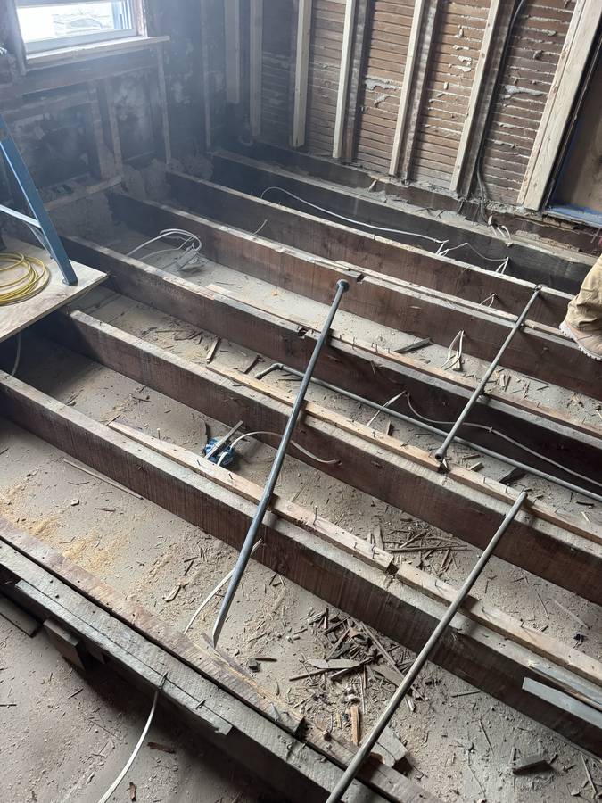 Floor framing opened up during a remodel, before the new structure goes in — Nexus Pro Construction